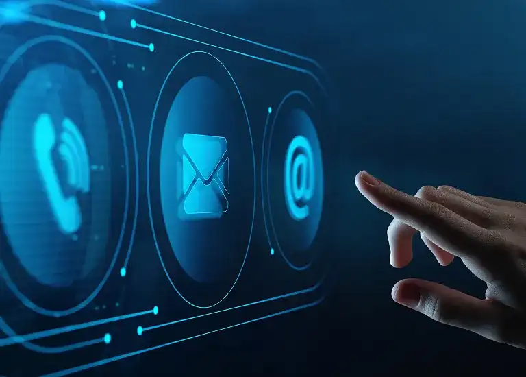 Hand interacting with futuristic blue digital icons of phone, email, and at symbol on screen.